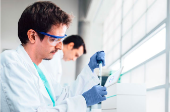 Person with glasses holding a container