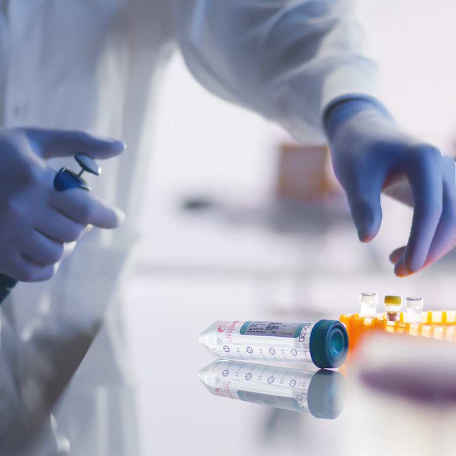 scientist reaching for sample in sequencing lab